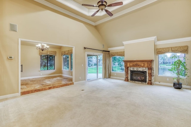 unfurnished living room with crown molding, high vaulted ceiling, carpet flooring, and a wealth of natural light