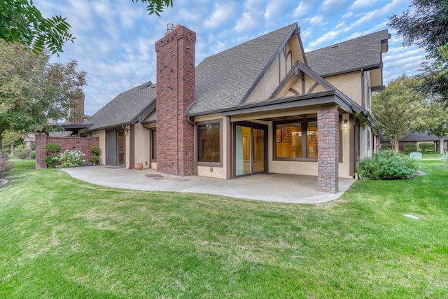 rear view of house featuring a patio and a lawn