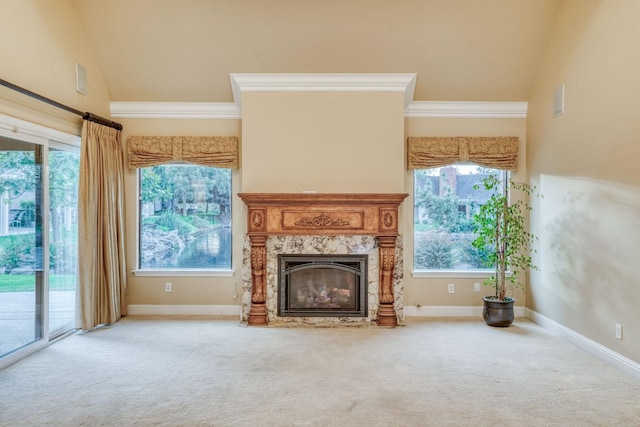 unfurnished living room featuring high vaulted ceiling, ornamental molding, carpet floors, and a high end fireplace