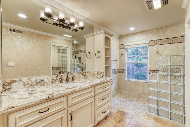 bathroom featuring vanity, a tile shower, and ornamental molding