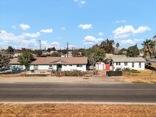 ranch-style house featuring a storage shed