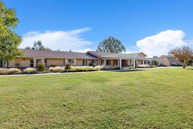 ranch-style house with a front lawn