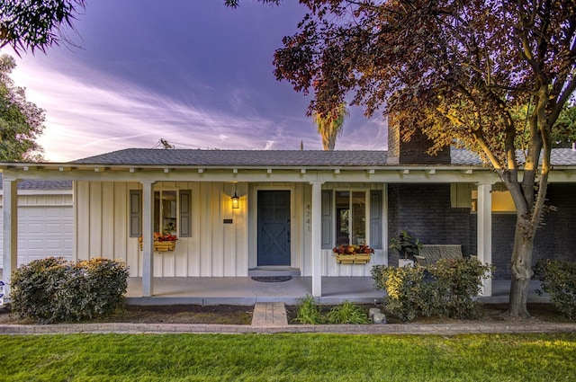 view of front of property featuring a garage and covered porch