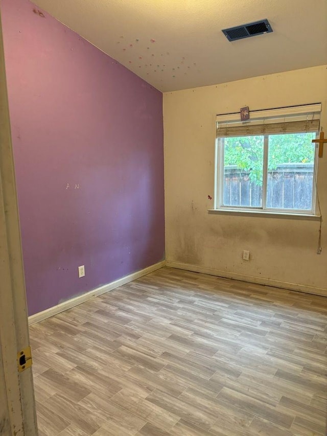 spare room with light hardwood / wood-style floors