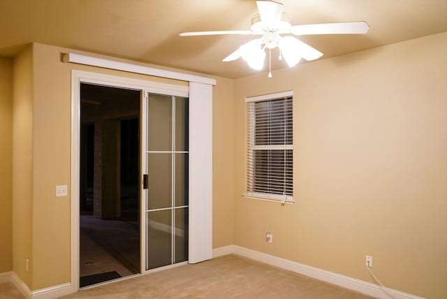 unfurnished room featuring light colored carpet and ceiling fan