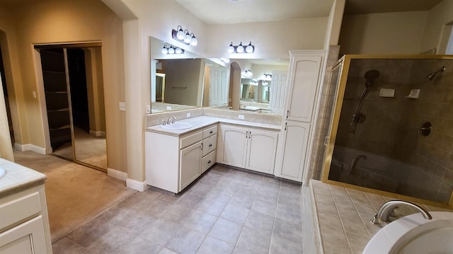 bathroom featuring walk in shower, tile patterned flooring, and vanity