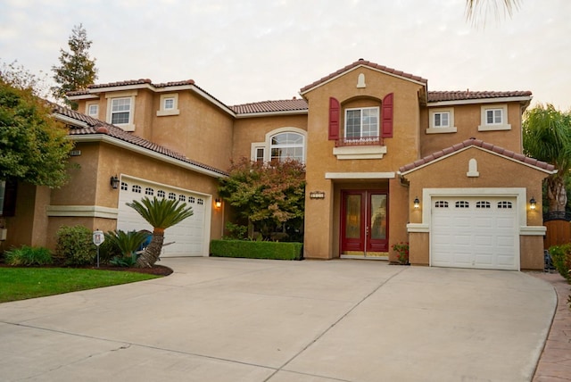 mediterranean / spanish-style house with a garage