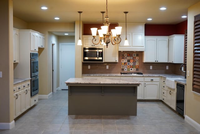 kitchen featuring white cabinetry, stainless steel appliances, sink, and a center island