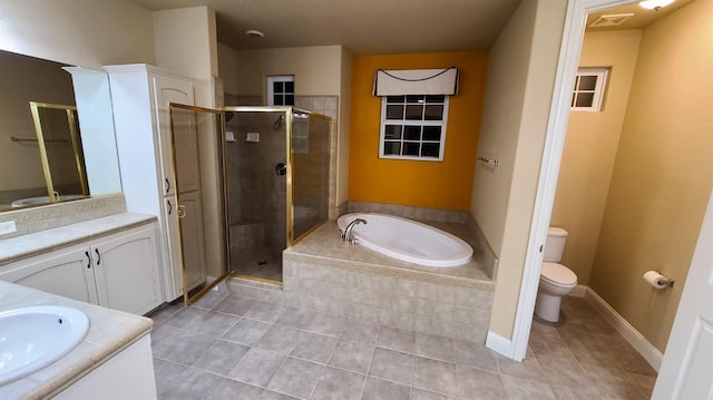 full bathroom featuring shower with separate bathtub, vanity, and toilet