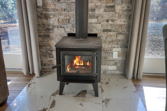 details featuring a wood stove and hardwood / wood-style floors