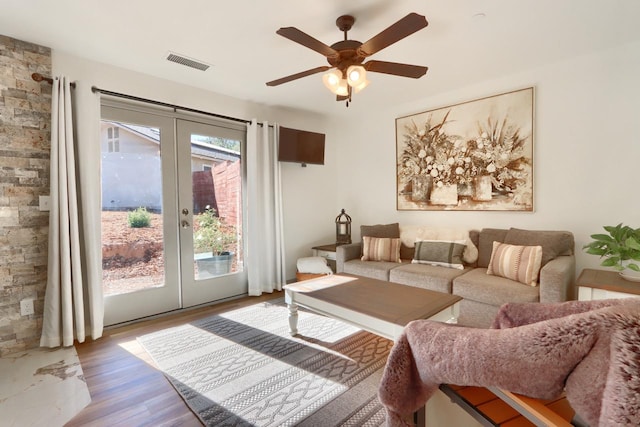 living room with french doors, hardwood / wood-style flooring, and ceiling fan