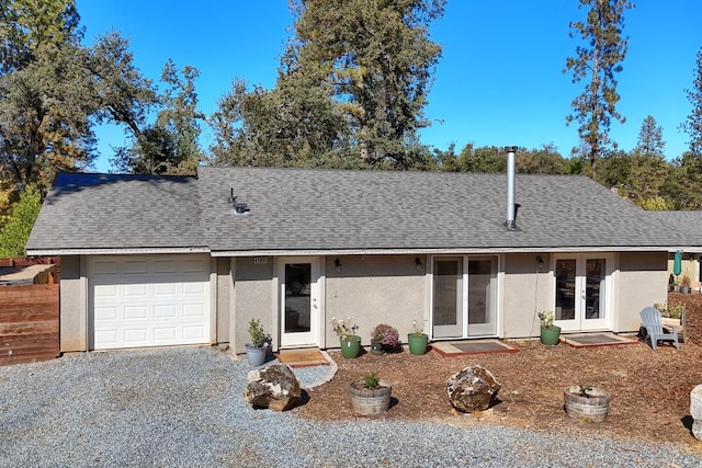 ranch-style home featuring french doors and a garage