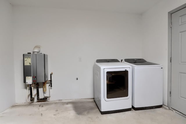 laundry area with water heater and washer and dryer