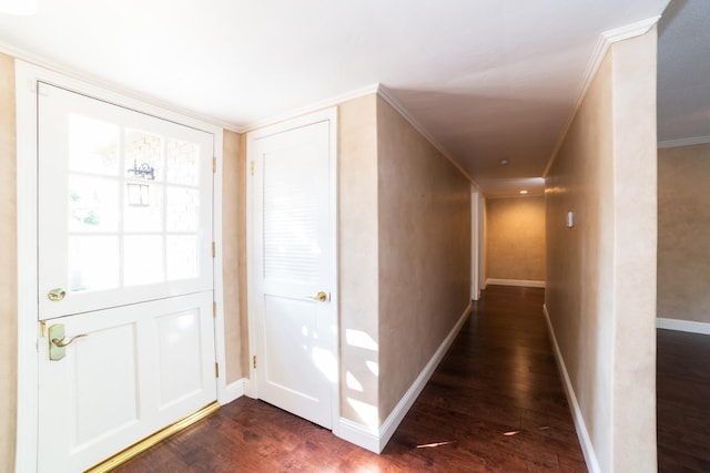 foyer featuring ornamental molding and dark hardwood / wood-style flooring