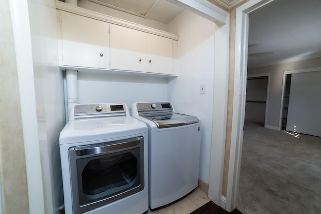 laundry room with cabinets and washing machine and clothes dryer