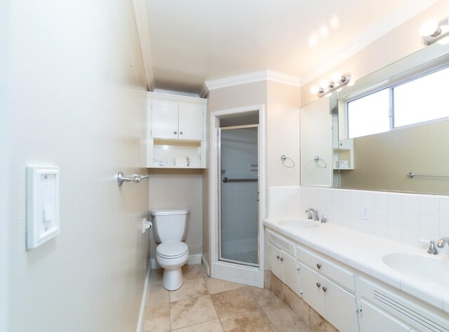 bathroom featuring backsplash, toilet, walk in shower, vanity, and crown molding