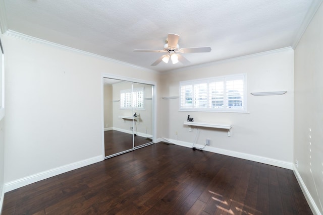 unfurnished bedroom featuring a closet, ceiling fan, wood-type flooring, and ornamental molding