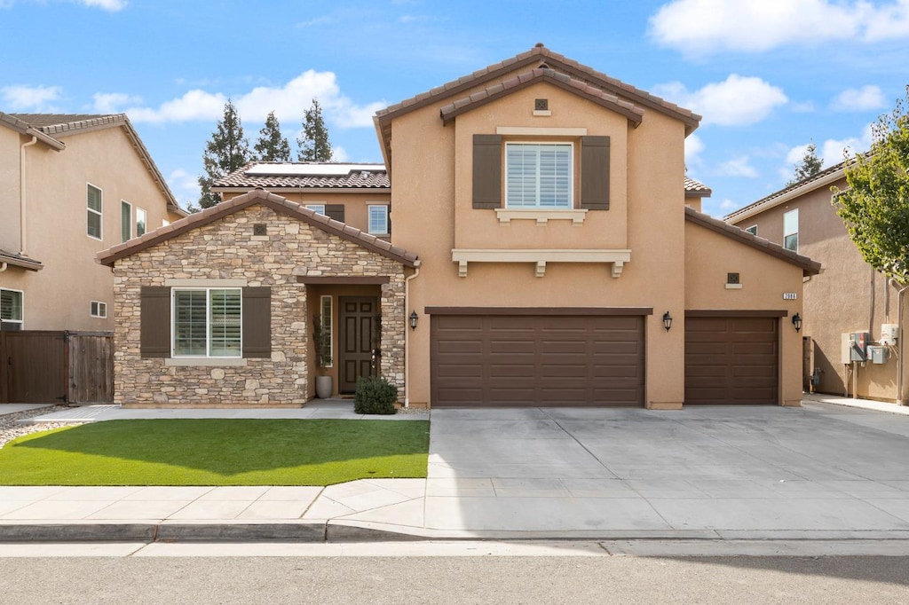 view of front facade featuring a garage and a front yard