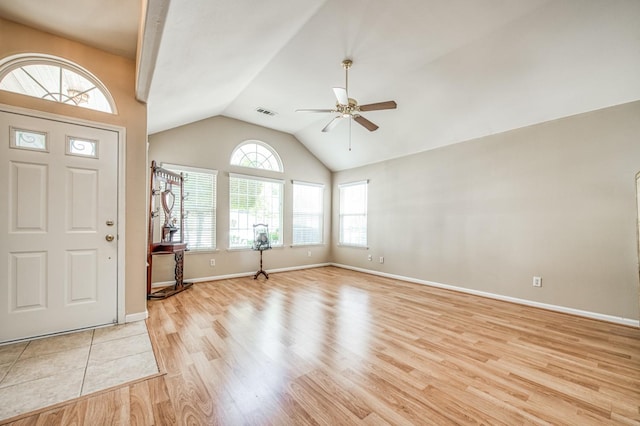 entryway featuring ceiling fan, light hardwood / wood-style floors, lofted ceiling, and a wealth of natural light