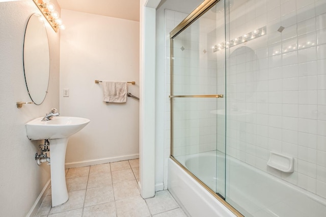 bathroom featuring combined bath / shower with glass door, tile patterned floors, and sink