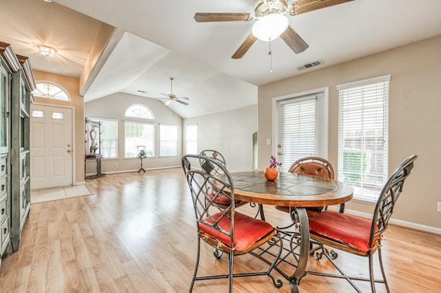 dining space featuring ceiling fan, light hardwood / wood-style floors, and vaulted ceiling