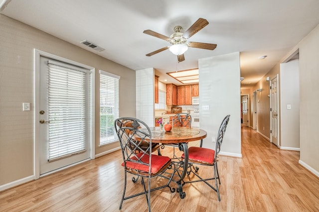 dining space featuring a wealth of natural light, light hardwood / wood-style flooring, and ceiling fan