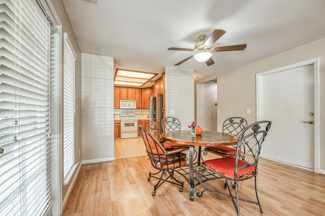 dining space featuring ceiling fan and light hardwood / wood-style floors