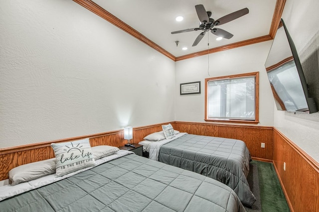 bedroom featuring wood walls, ceiling fan, and crown molding