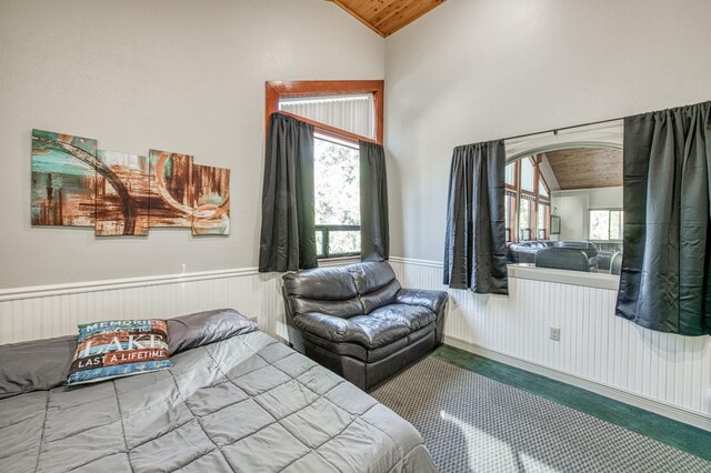 bedroom with multiple windows, vaulted ceiling, and wooden ceiling