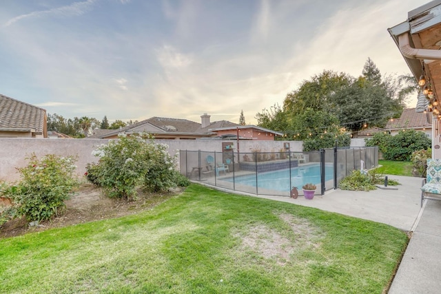 view of pool with a yard and a patio area