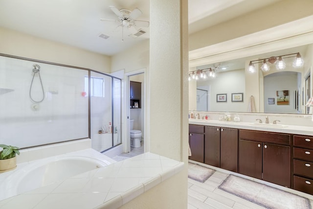 full bathroom featuring toilet, vanity, shower with separate bathtub, and ceiling fan