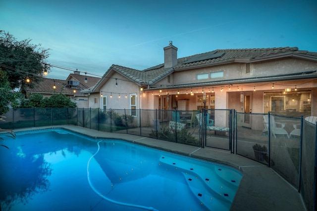 view of pool at dusk