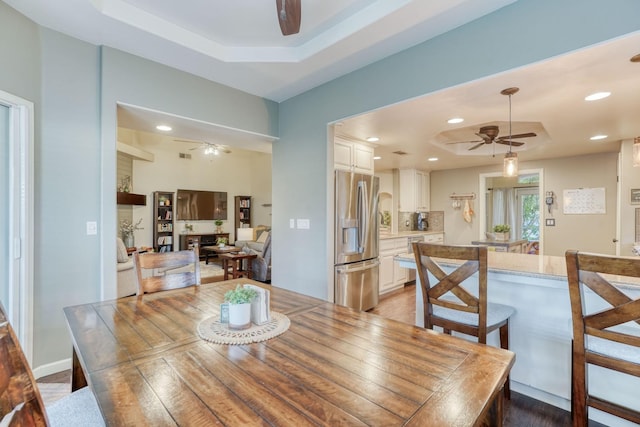 dining area with a raised ceiling