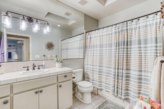 full bathroom featuring wood-type flooring, vanity, shower / bath combo, and toilet