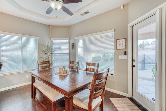 dining space featuring a wealth of natural light and dark hardwood / wood-style flooring