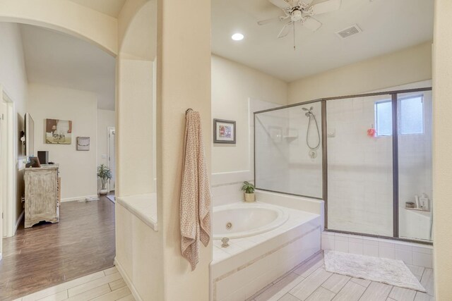 bathroom with shower with separate bathtub and ceiling fan