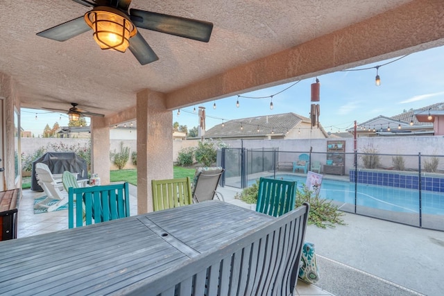 view of patio featuring area for grilling, ceiling fan, and a fenced in pool