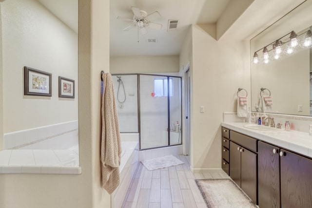 bathroom with shower with separate bathtub, vanity, and ceiling fan