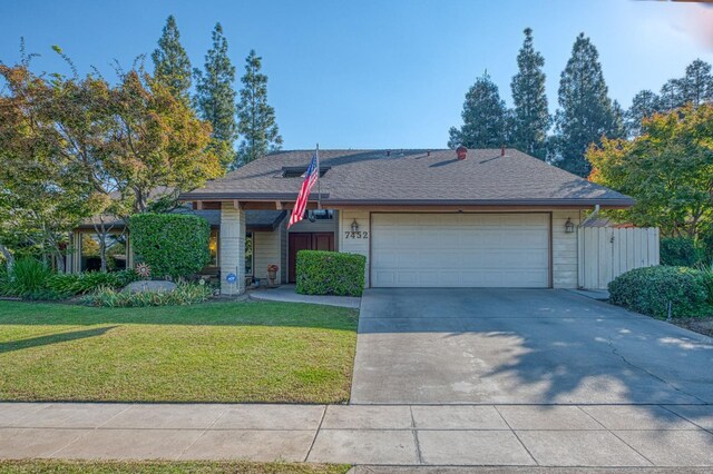 view of front of home with a garage and a front yard