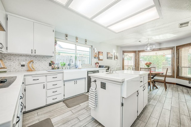 kitchen with visible vents, light countertops, white cabinetry, and wood tiled floor