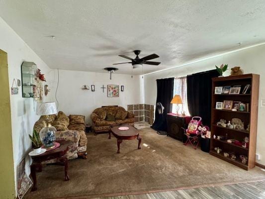 living room featuring a textured ceiling and ceiling fan