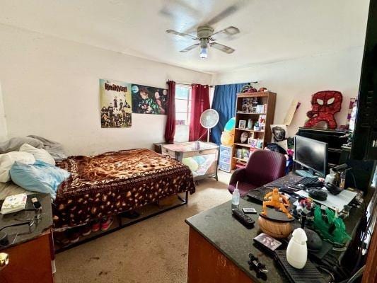 bedroom featuring ceiling fan and carpet