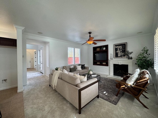 living room with crown molding, light tile patterned flooring, and ceiling fan