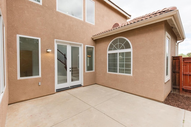 rear view of house with french doors and a patio