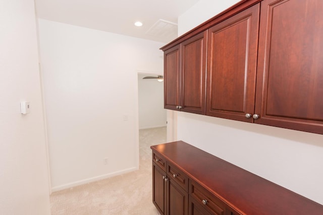 hallway featuring light colored carpet