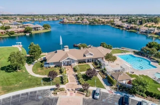 birds eye view of property with a water view