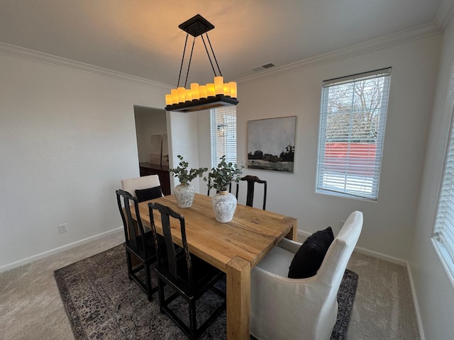 carpeted dining space featuring ornamental molding