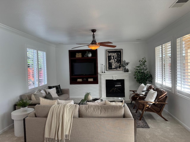 living room featuring crown molding, carpet floors, and ceiling fan