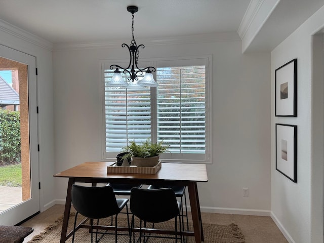 dining area featuring ornamental molding and an inviting chandelier