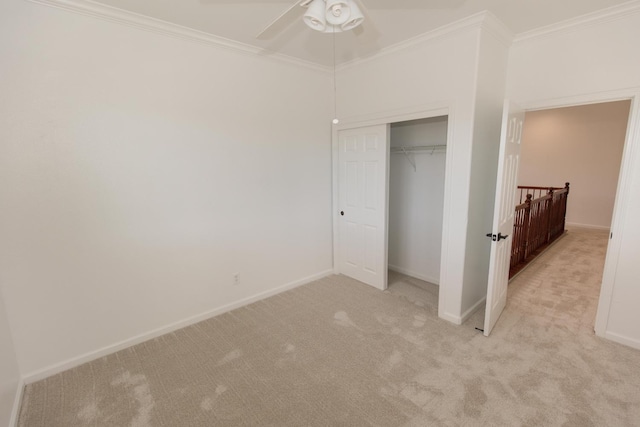 unfurnished bedroom featuring ornamental molding, light colored carpet, a closet, and ceiling fan